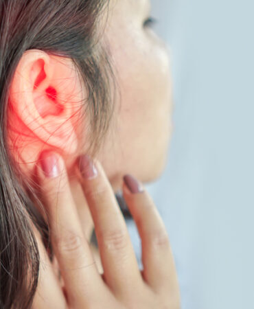woman suffering from ear pain , Tinnitus concept